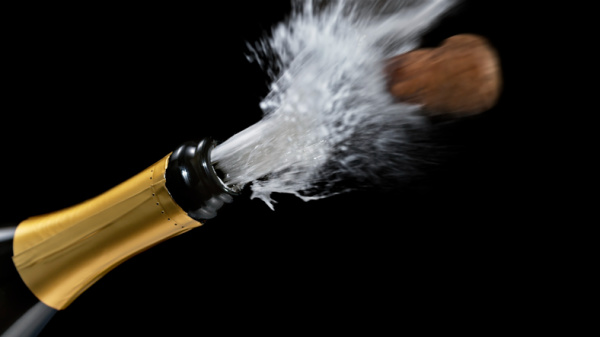 Close up of popping champagne cork